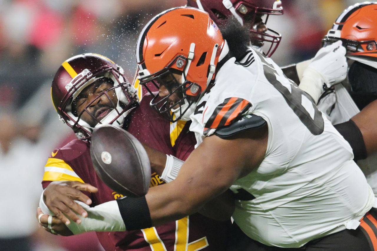 Washington Commanders quarterback Jacoby Brissett is sacked by Cleveland Browns defensive lineman Siaki Ika during an NFL preseason game on Friday, August 11.