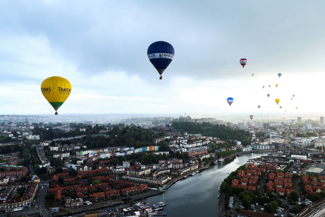 Hot-air balloons fly over Bristol, England, during the annual Bristol International Balloon Fiesta on Friday, August 11.