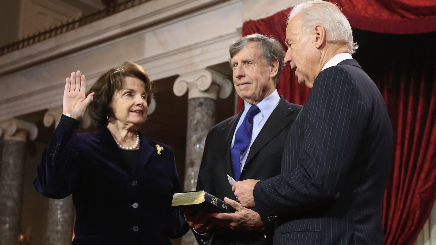 Sen. Dianne Feinstein participates in a reenacted swearing-in with her husband Richard Blum and Vice President Joe Biden on January 3, 2013 in Washington, DC.