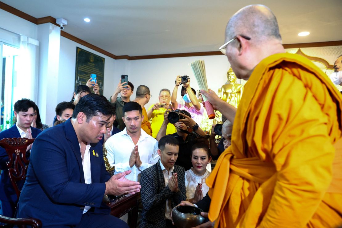 Vacharaesorn Vivacharawongse is blessed by a Buddhist monk during a religious ceremony at Wat Yannawa temple in Bangkok, Thailand, on August 10.