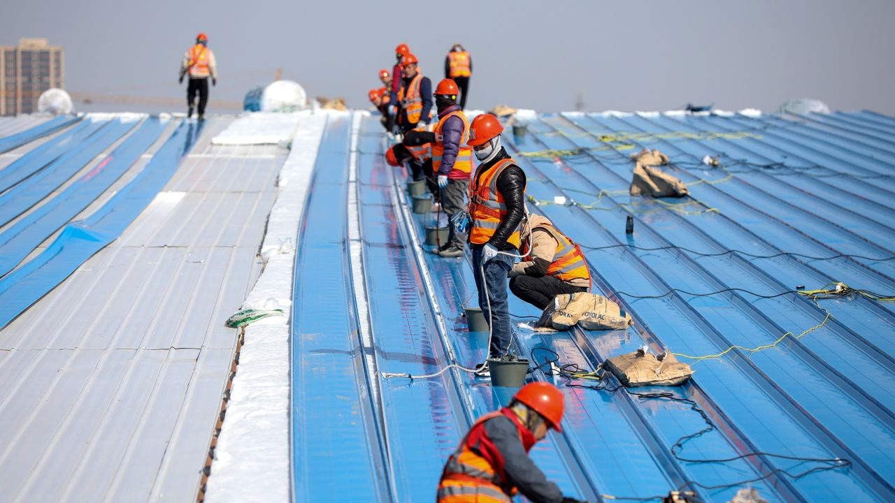 Workers work at the Trina Solar project site in Huai 'an, Jiangsu province, China, February 14, 2023. This project is the third-generation N-type photovoltaic cell production base, mainly producing N-type i-TOPCon photovoltaic cells and 210mm high-power photovoltaic modules. It is implemented in two phases, including 5GW cells +10GW modules in the first phase and 10GW cells +5GW modules in the second phase. After completion, it will provide more than 5,000 jobs and achieve an annual output value of about 40 billion yuan. 
