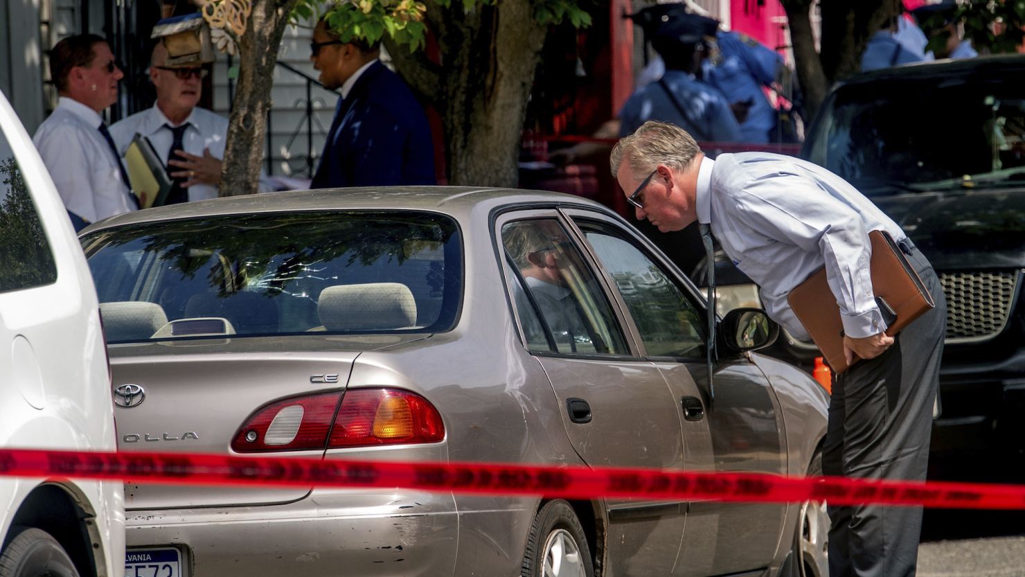 Authorities work the scene after a Philadelphia police officer fatally shot a man Monday. 