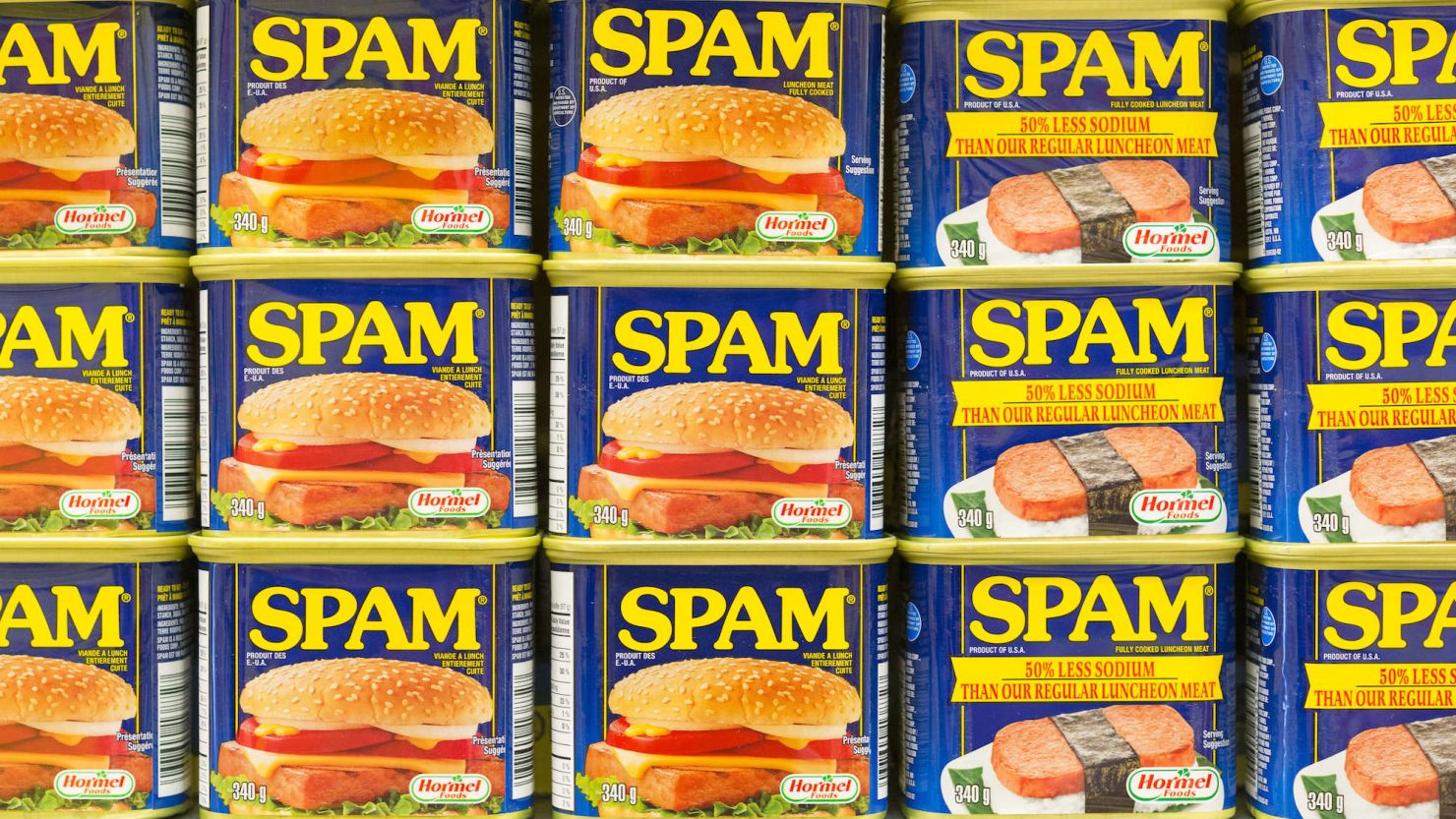 Spam canned meat stacked vertically on a store shelf. 