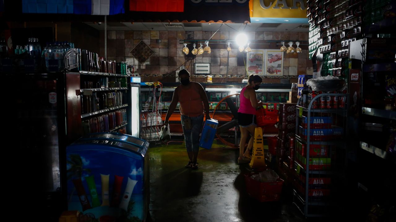 Shoppers stock up on supplies at a grocery store during the blackout after Hurricane Ida in New Orleans on Sept. 2, 2021. 