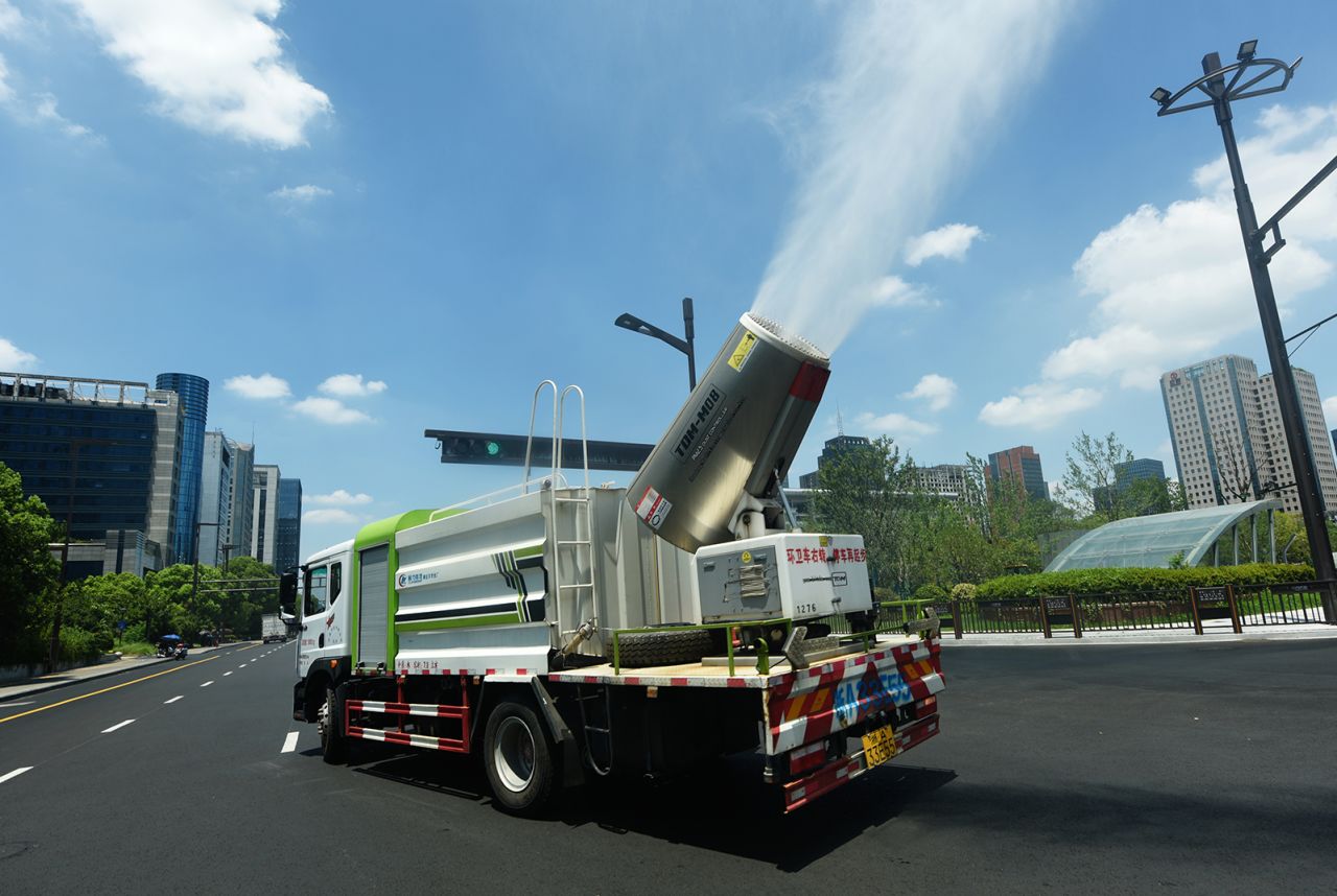 A large fog gun truck sprays water mist to cool the area on a street in Hangzhou, East China's Zhejiang Province, August 3, 2022.
