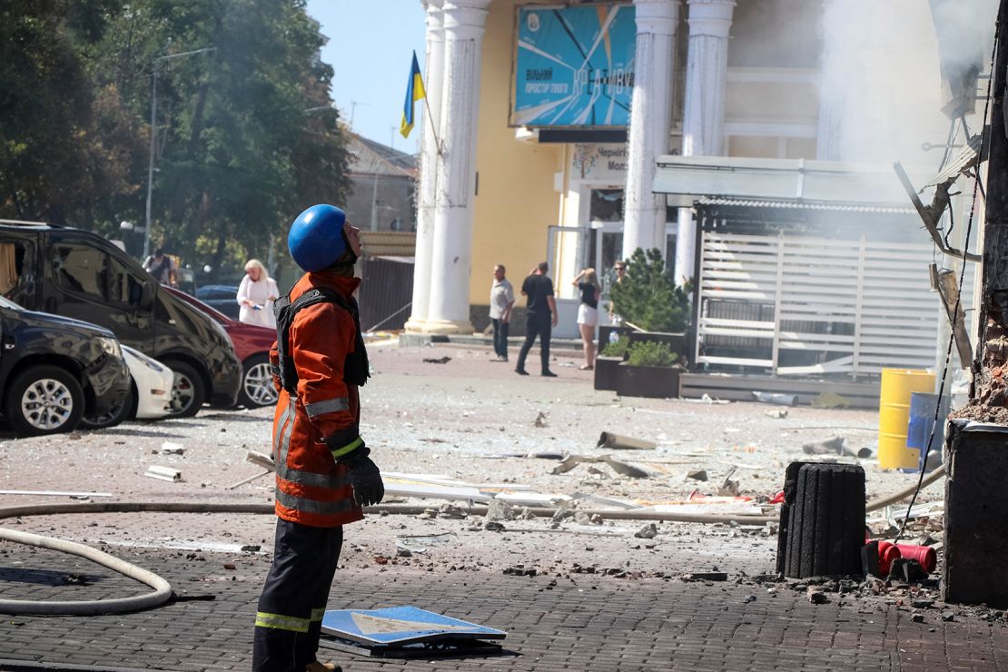An emergency service worker stands at the site of a Russian missile strike in Chernihiv. 