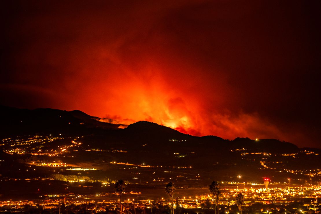 Flares are seen on the horizon as the fire advances through the forest toward the town of La Laguna and Los Rodeos airport.