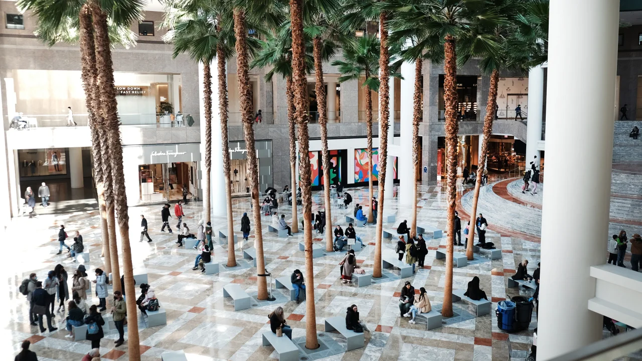 People sit in a public area in the Brookfield Place Mall