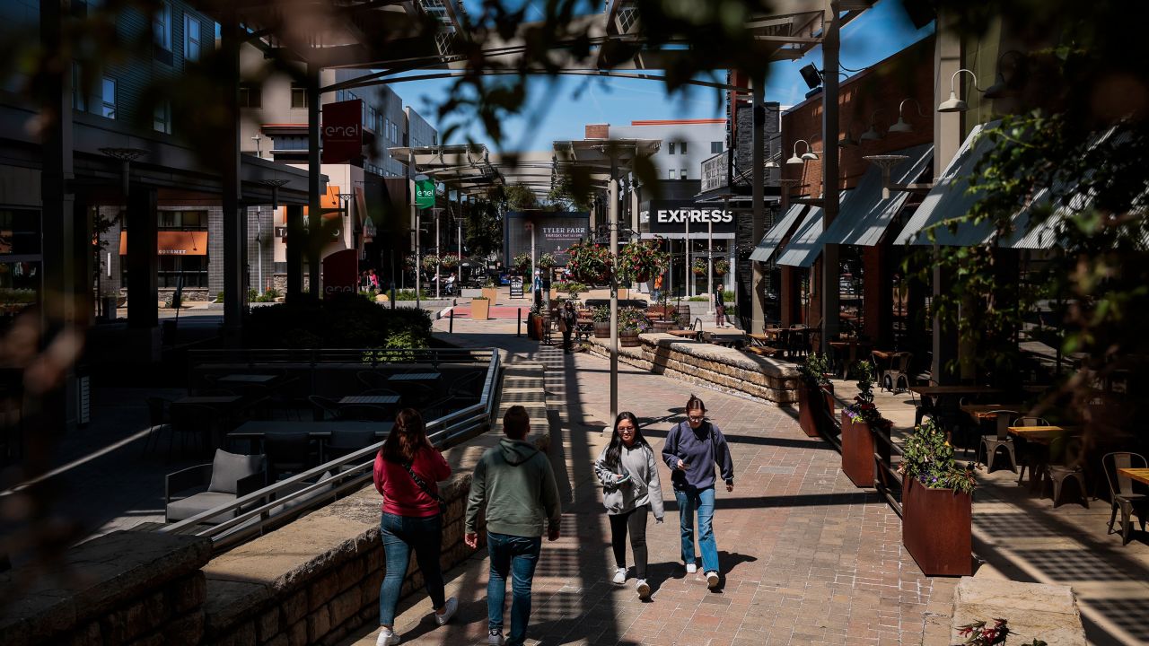 People stroll through a shopping mall in Foxborough, Massachusetts, on May 18, 2023.