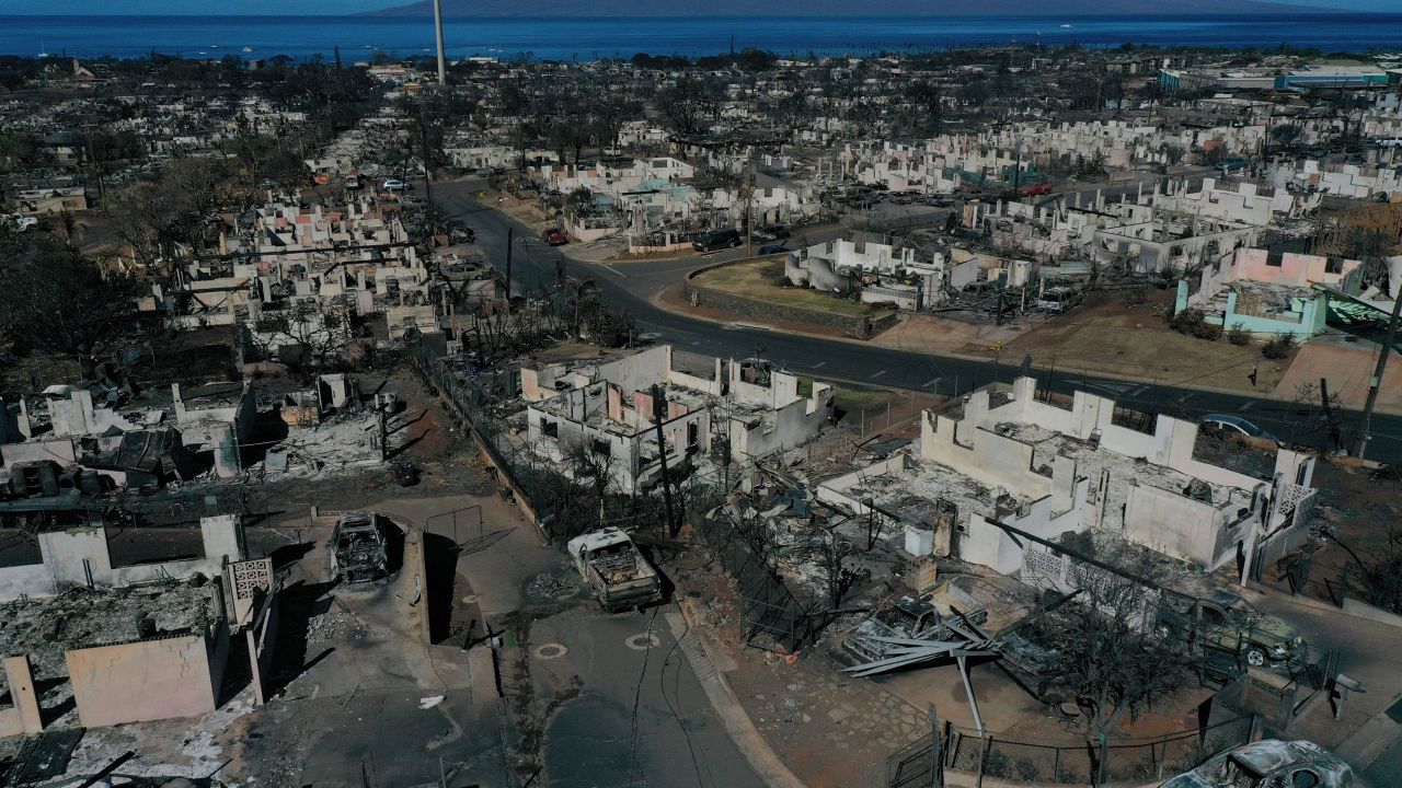 TOPSHOT - An aerial image shows destroyed homes and vehicles after a wind driven wildfire burned from the hills through neighborhoods to the Pacific Ocean, as seen in the aftermath of the Maui wildfires in Lahaina, Hawaii, on August 17, 2023. Embattled officials in Hawaii who have been criticized for the lack of warnings as a deadly wildfire ripped through a town insisted on August 16 that sounding emergency sirens would not have saved lives. At least 110 people died when the inferno levelled Lahaina last week on the island of Maui, with some residents not aware their town was at risk until they saw flames for themselves. (Photo by Patrick T. Fallon / AFP) (Photo by PATRICK T. FALLON/AFP via Getty Images)