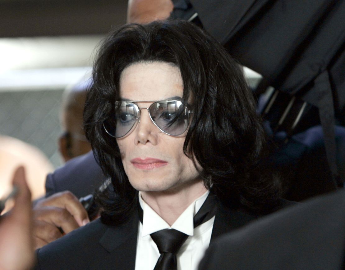 SANTA MARIA, CA - JUNE 13: Michael Jackson prepares to enter the Santa Barbara County Superior Court to hear the verdict read in his child molestation case June 13, 2005 in Santa Maria, California. After seven days of deliberation the jury has reached a not guilty verdict on all 10 counts in the trial against Michael Jackson. Jackson was charged in a 10-count indictment with molesting a boy, plying him with liquor and conspiring to commit child abduction, false imprisonment and extortion. He pleaded innocent. (Photo by Kevork Djansezian-Pool/Getty Images)