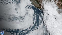 This Saturday, Aug. 19, 2023 11:38 a.m. EDT satellite image provided by the National Oceanic and Atmospheric Administration shows Hurricane Hilary, right, off Mexico's Pacific coast. Hurricane Hilary headed for Mexico's Baja California on Saturday as the U.S. National Hurricane Center predicted "catastrophic and life-threatening flooding" for the peninsula and for the southwestern United States, where it was forecast to cross the border as a tropical storm on Sunday. (NOAA via AP)