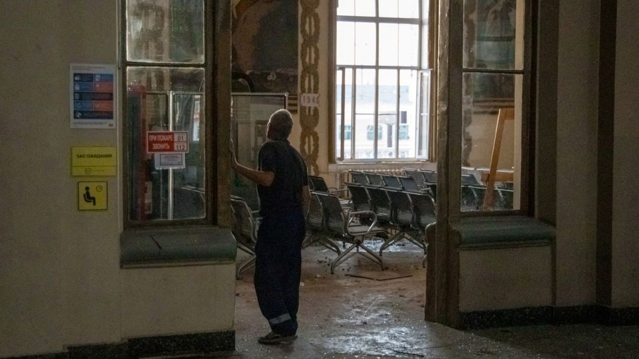 A man walks in a damaged hall of the station. 