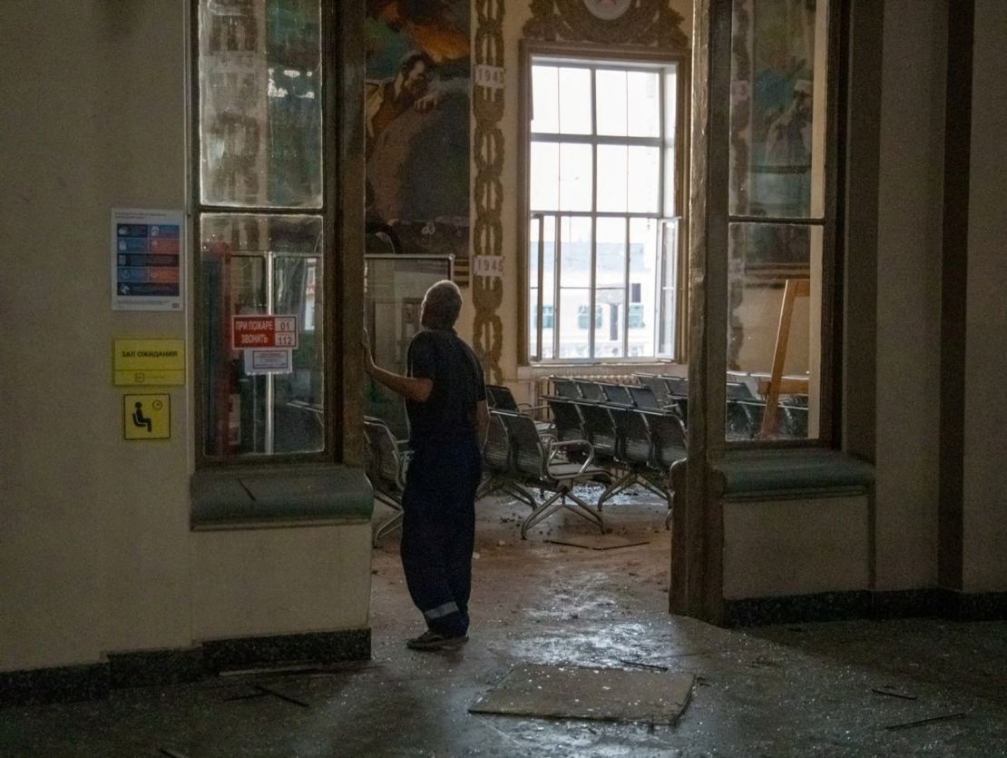 A man walks into a damaged hall of the station. 