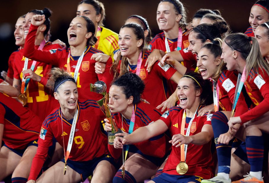 Spanish players celebrate with the trophy during the post-match award ceremony.