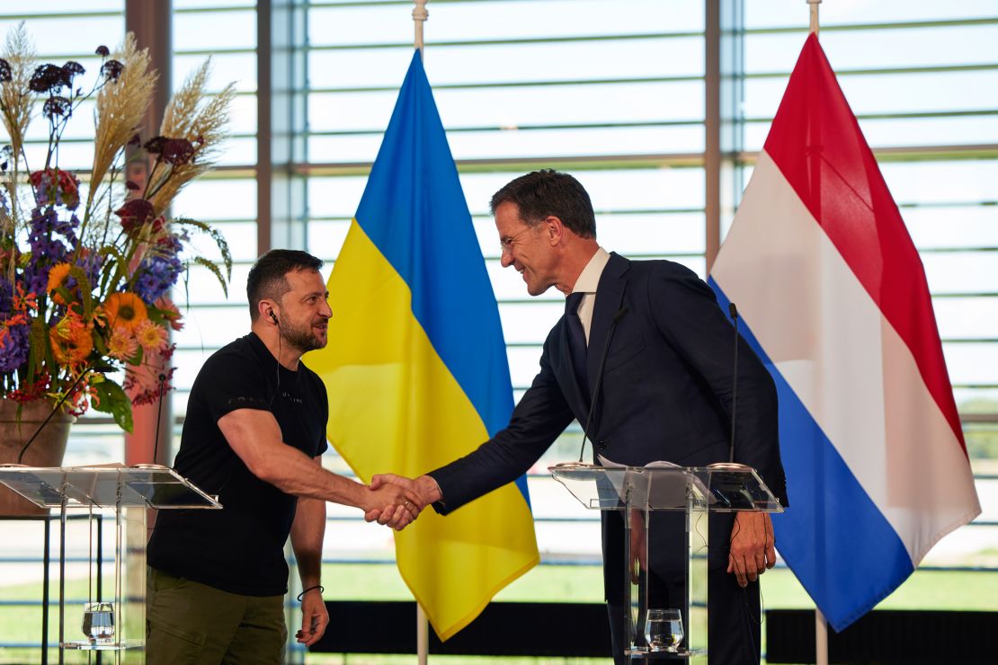 Volodymyr Zelenskiy shakes hands with Mark Rutte.