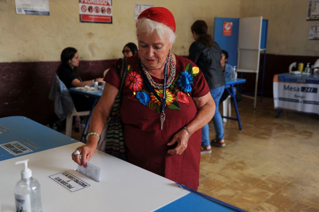 A woman casts her vote at a polling station during the presidential run-off election in Guatemala City, Guatemala, on August 20, 2023.