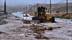 A plow clears debris along a flooded Sierra Highway in Palmdale, Calif., as Tropical Storm Hilary moves through the area on Sunday, Aug. 20, 2023. (AP Photo/Richard Vogel)