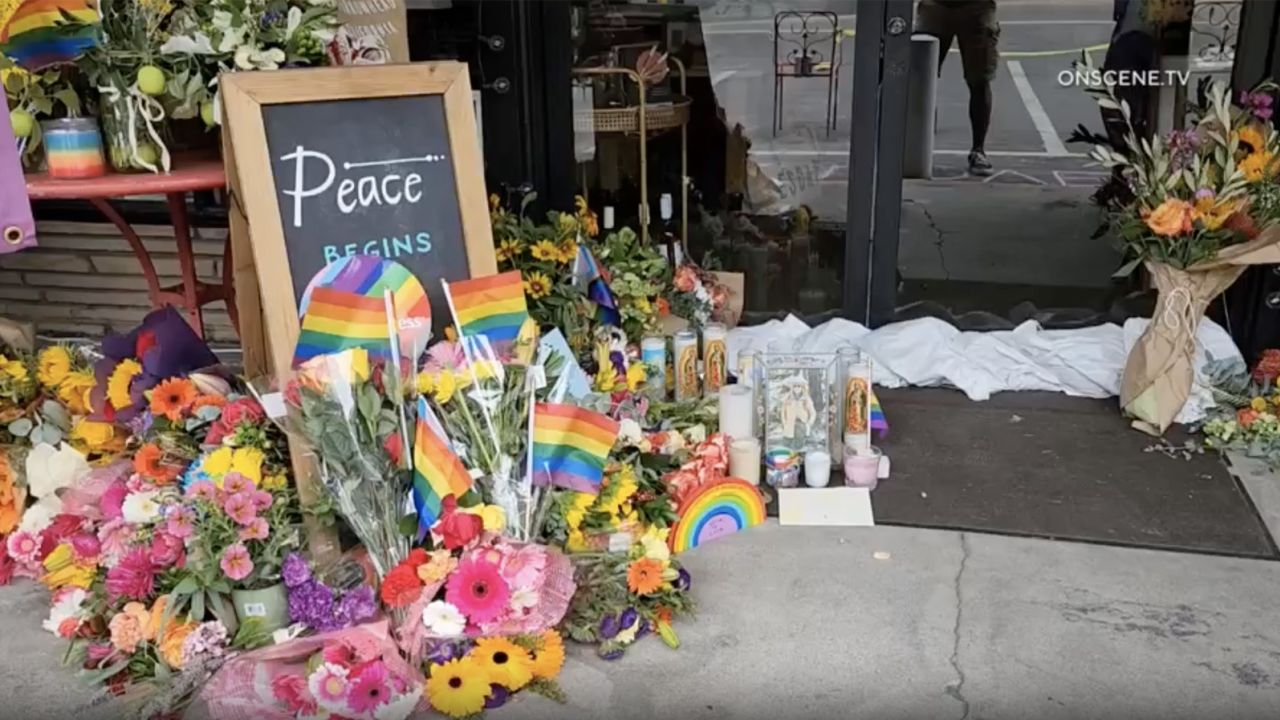 A memorial sits outside a clothing store in Cedar Glen, California, where deputies say the owner was killed following an argument over a Pride flag.