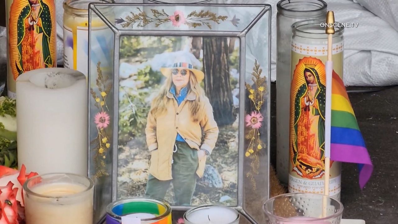 A memorial for Laura Ann Carleton is seen outside a clothing store.
