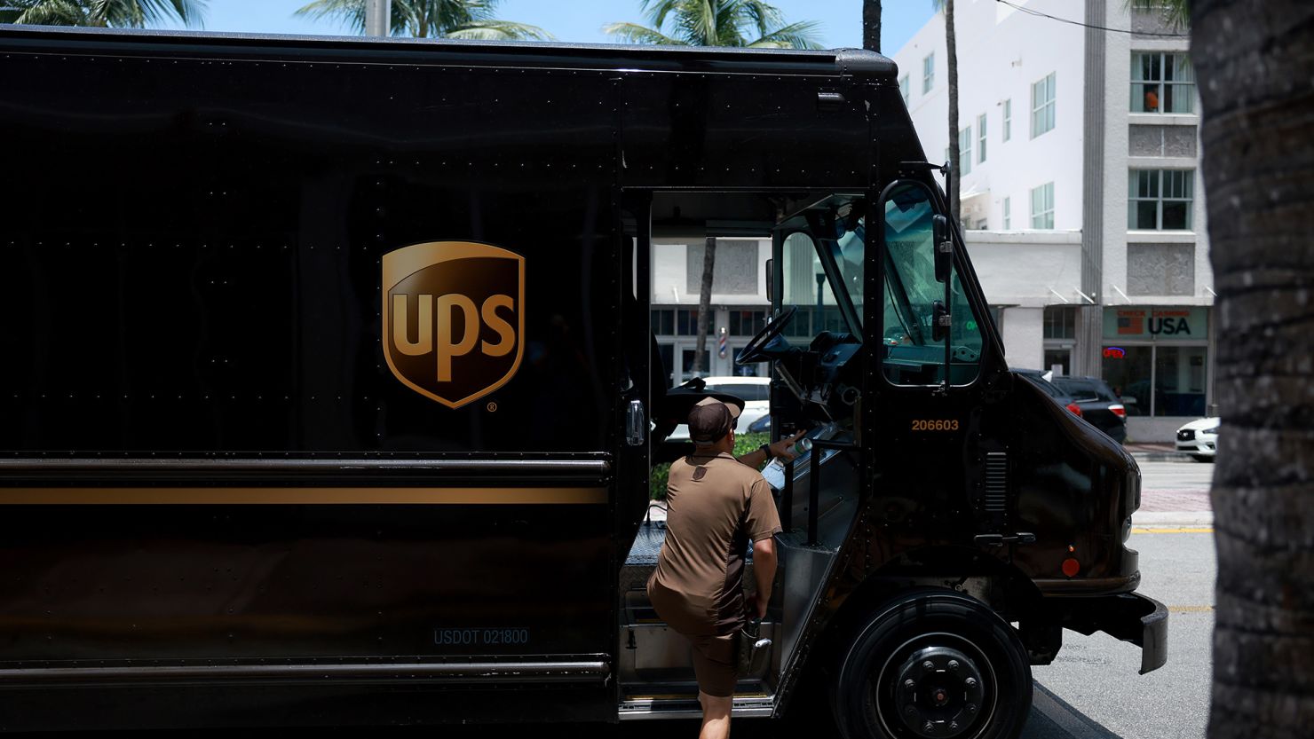 A UPS driver makes a delivery on June 30, 2023 in Miami, Florida. 