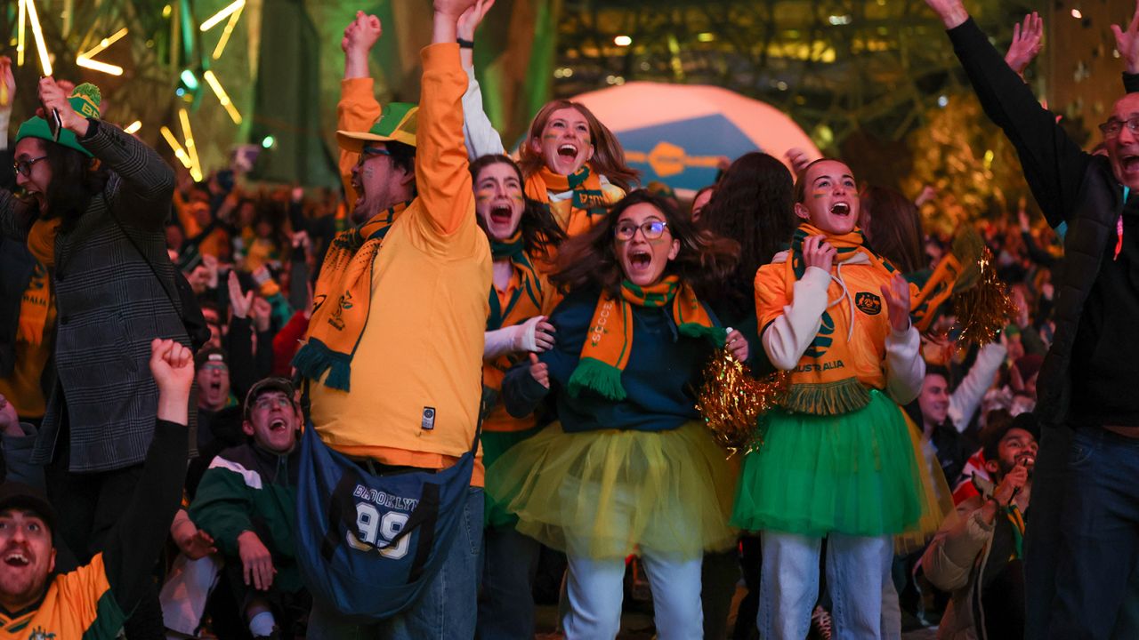 Australia fans celebrate at Melbourne's Federation Square after the Matildas scored the opening goal in their FIFA World Cup round-of-16 match against Denmark on August 7.