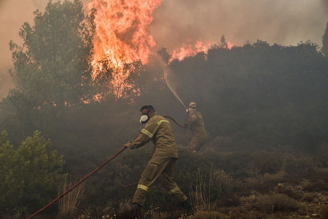 Firefighters battle flames during a wildfire near Prodromos on August 21, 2023. 