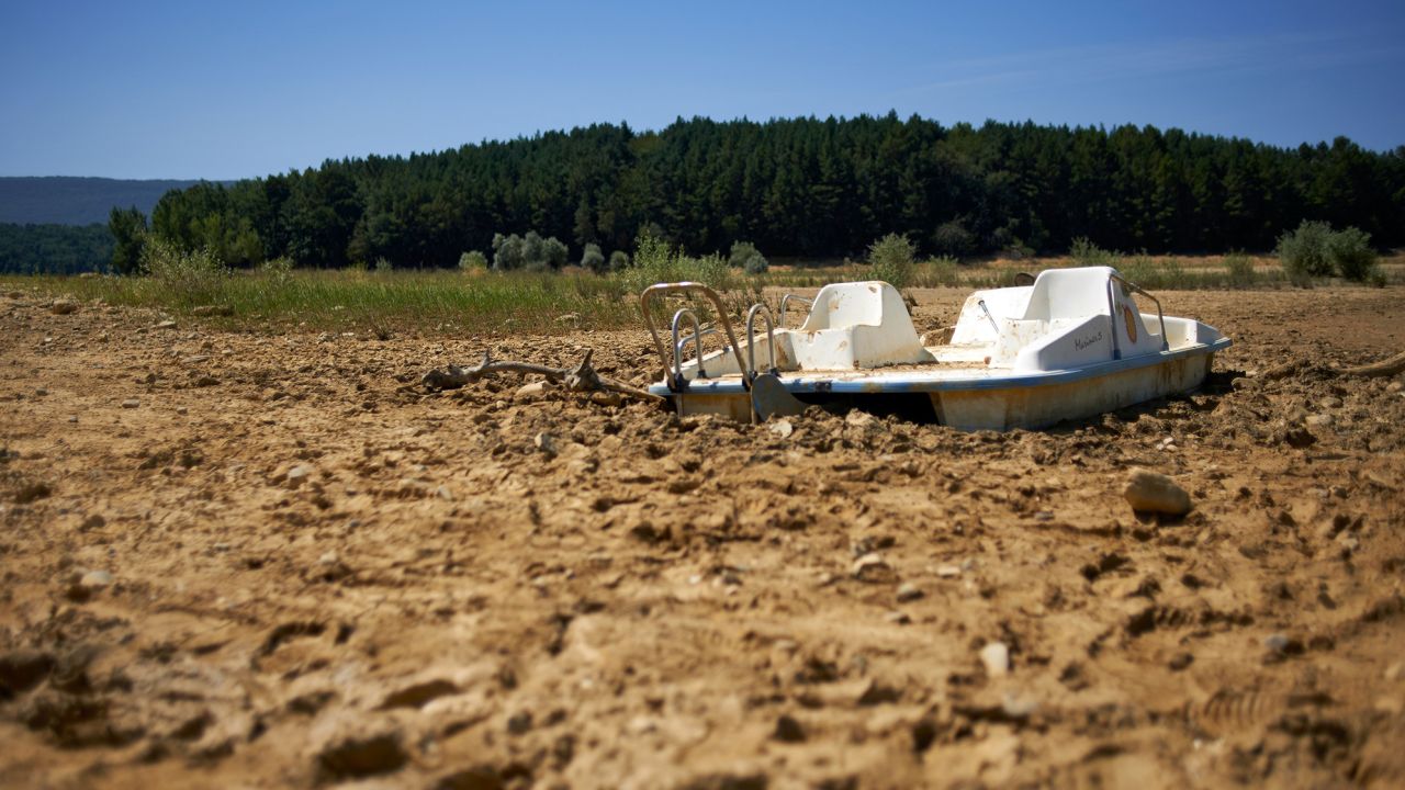 A paddle boat lies in the mud at the bottom of Lake Montbel, on August 18, 2023. Montbel is well below its normal level due to the unprecedented drought.