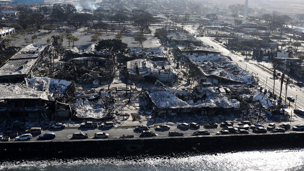 In an aerial view, cars destroyed by wildfire line Front Street on August 11, 2023 in Lahaina, Hawaii. 