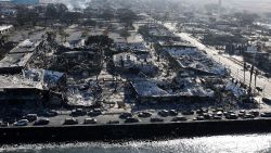 In an aerial view, cars destroyed by wildfire line Front Street on August 11, 2023 in Lahaina, Hawaii. 