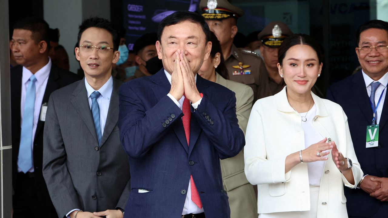 El ex primer ministro tailandés Thaksin Shinawatra, flanqueado por su hijo Panthongtae Shinawatra y su hija Paetongtarn Shinawatra en el aeropuerto Don Mueang de Bangkok, Tailandia, el 22 de agosto de 2023. 