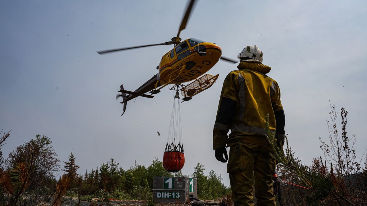 French firefighters try to put out a wildfire in La Roche in Quebec, Canada, on June 28, 2023. 