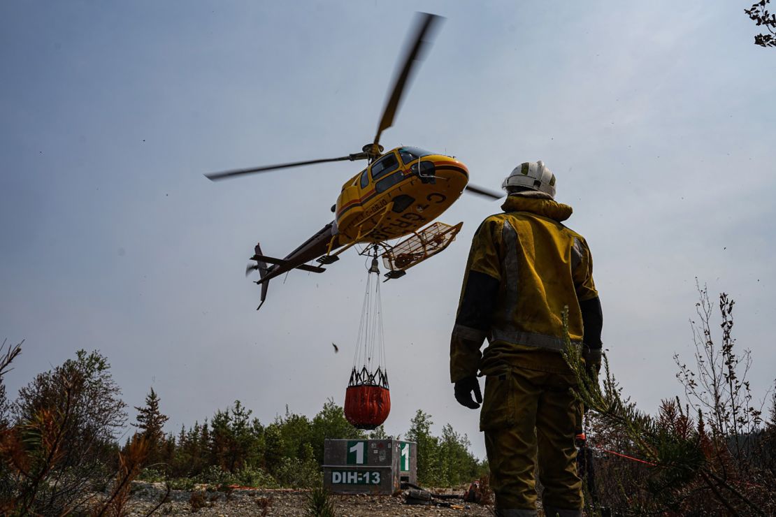 French firefighters try to extinguish wildfires at Lac Larouche in Quebec, Canada, on June 28, 2023. 