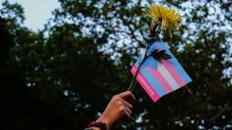 A person holds a transgender pride flag and a flower during a Black Trans Liberation protest in New York, United States, May 31, 2023. REUTERS/Amr Alfiky