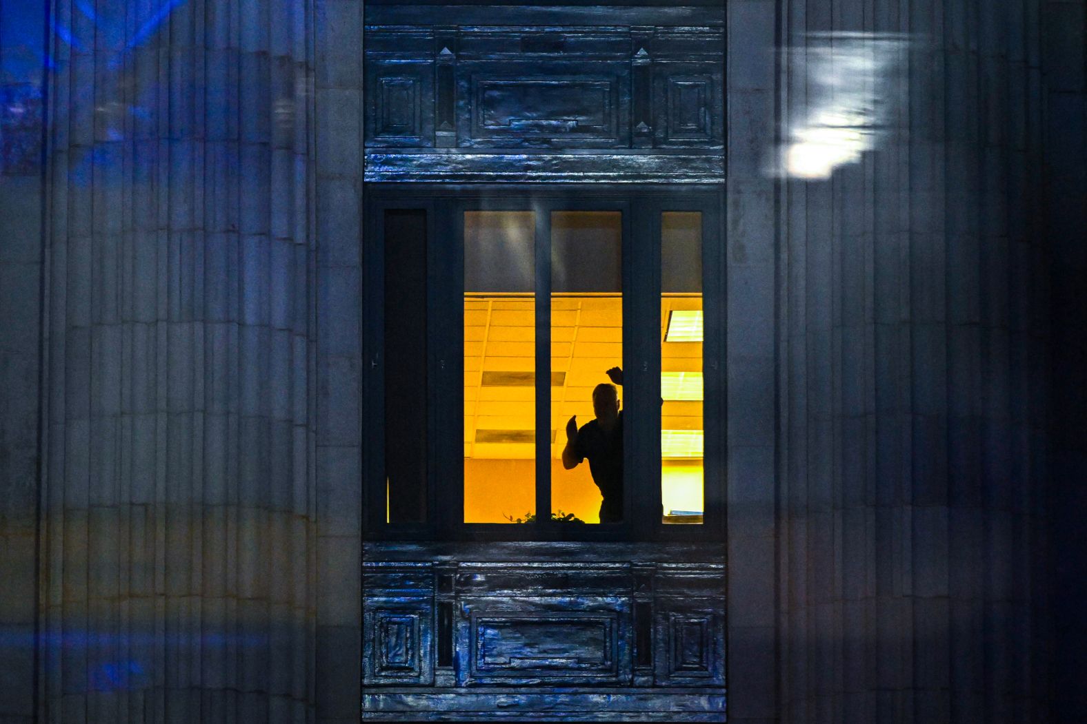 A person looks out a window at the Fulton County Courthouse on August 14.