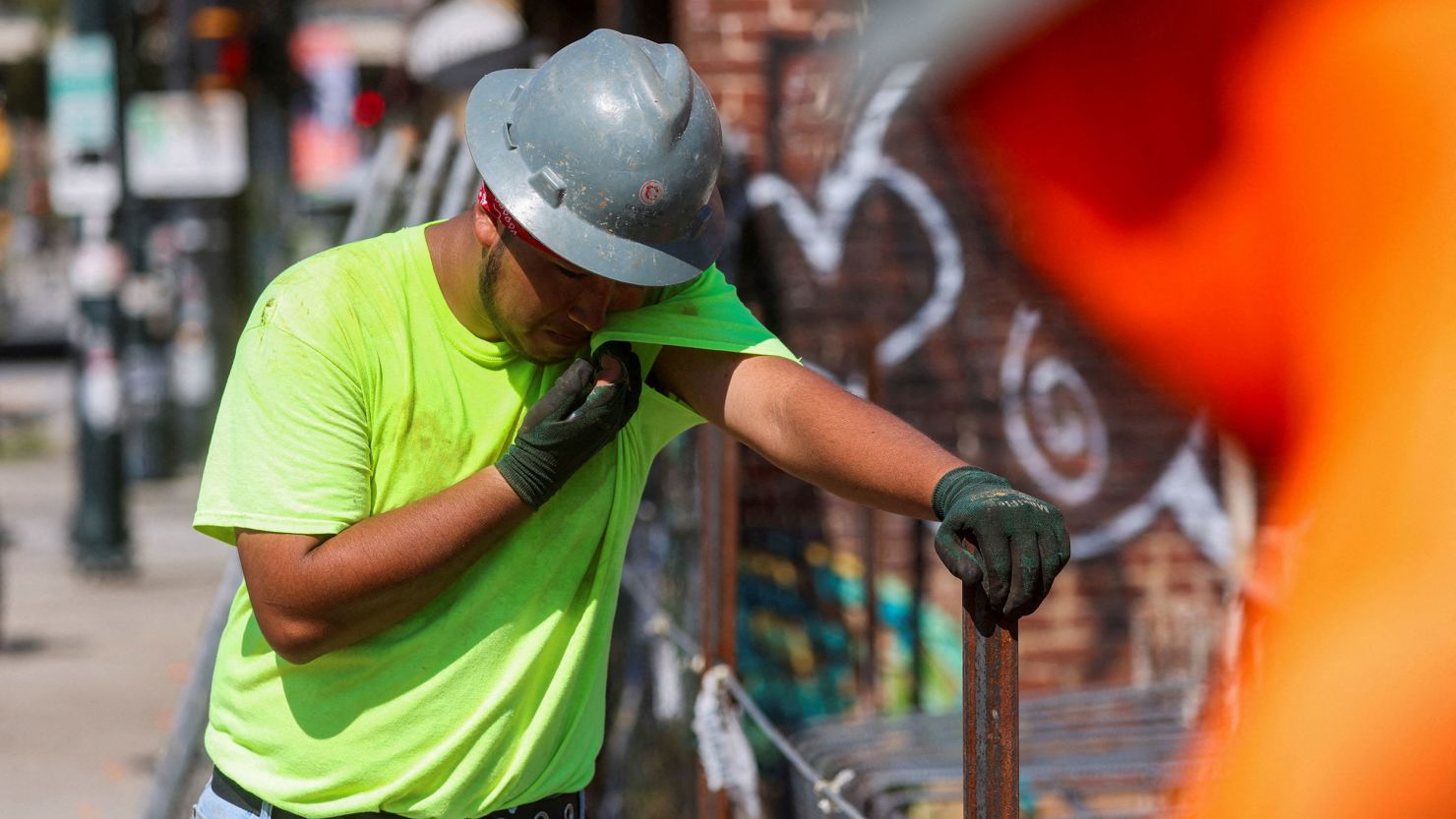 A construction worker wipes sweat from his face in high heat in Atlanta.