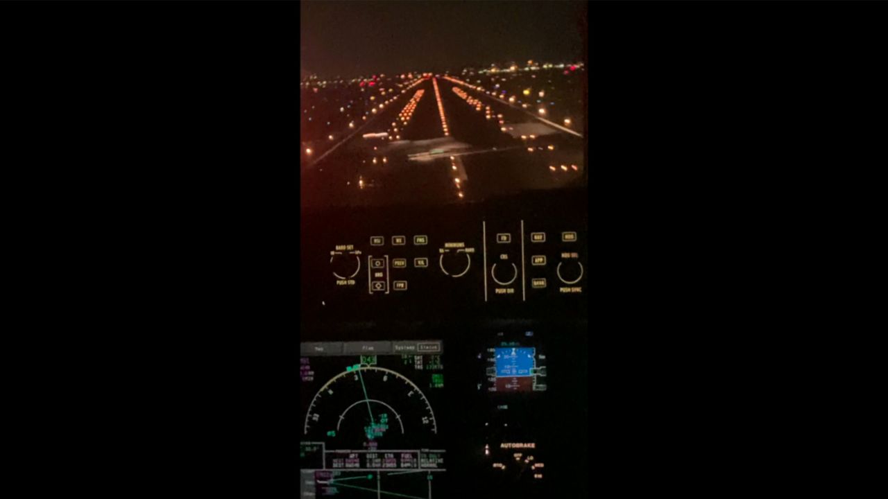 This screen capture from a jump-seat occupant's video shows the Learjet passing in front of the JetBlue plane at Boston Logan International Airport in February.