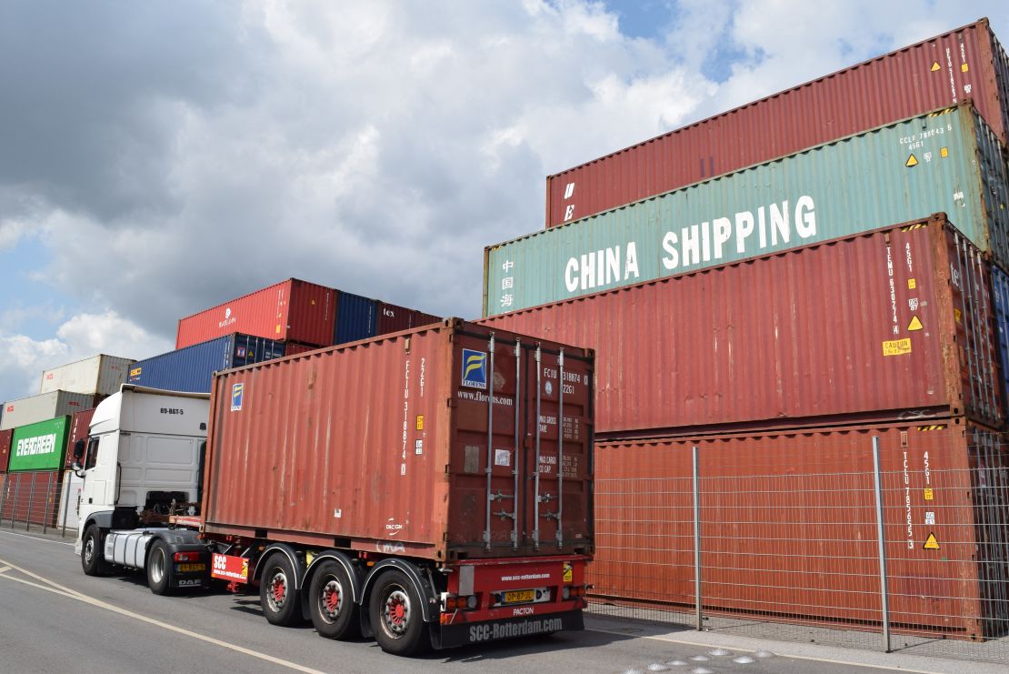 A truck drives past containers piled up at the German port in Duisburg in June. 