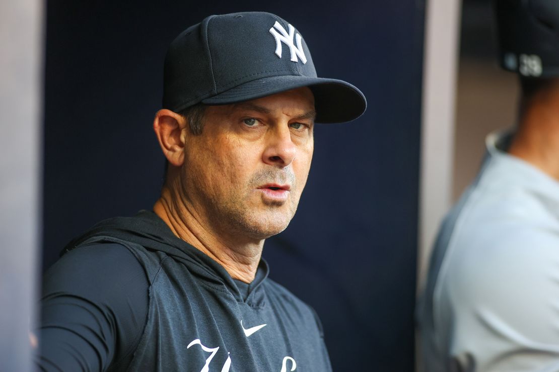 New York Yankees manager Aaron Boone (17) in the dugout before a game against the Atlanta Braves at Truist Park on August 16, 2023.
