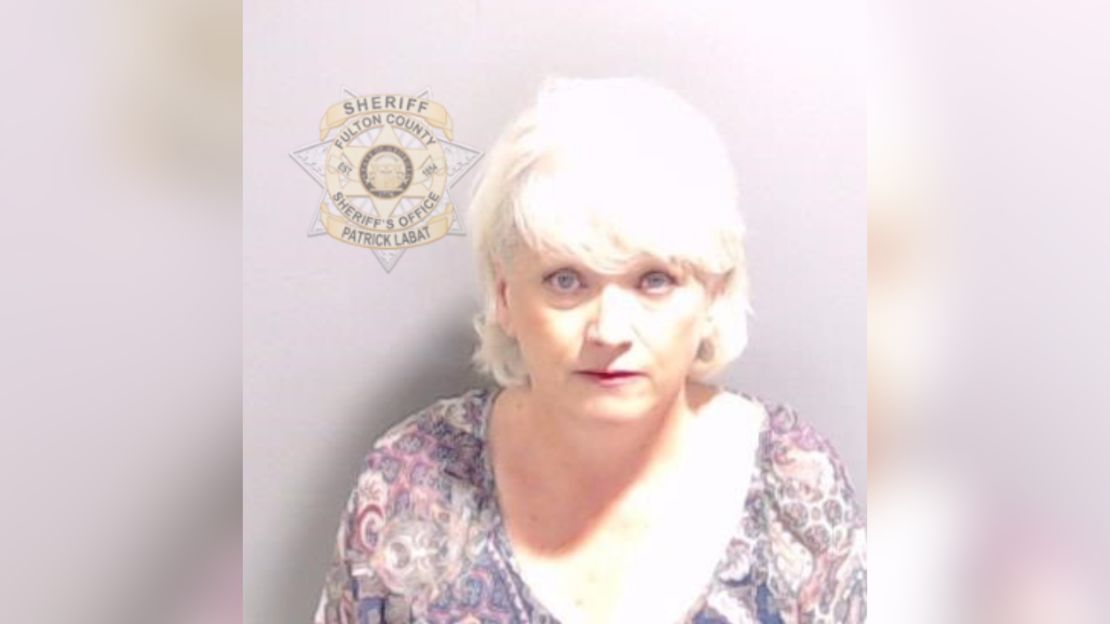 Former county GOP chair Cathy Latham, pictured in her booking photo, escorted visitors to the election office days after urging people to "out-vote the fraud."
