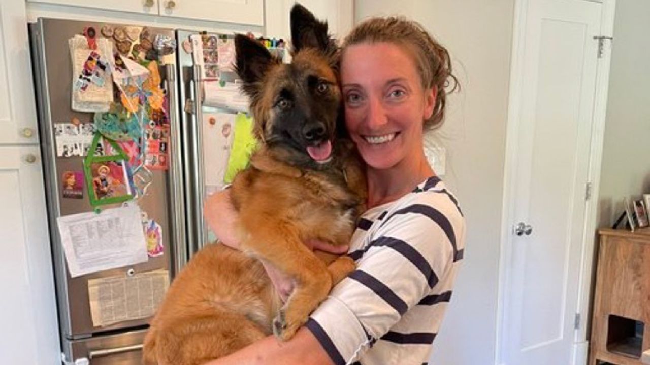 Colleen Costello holds her dog, Maple.