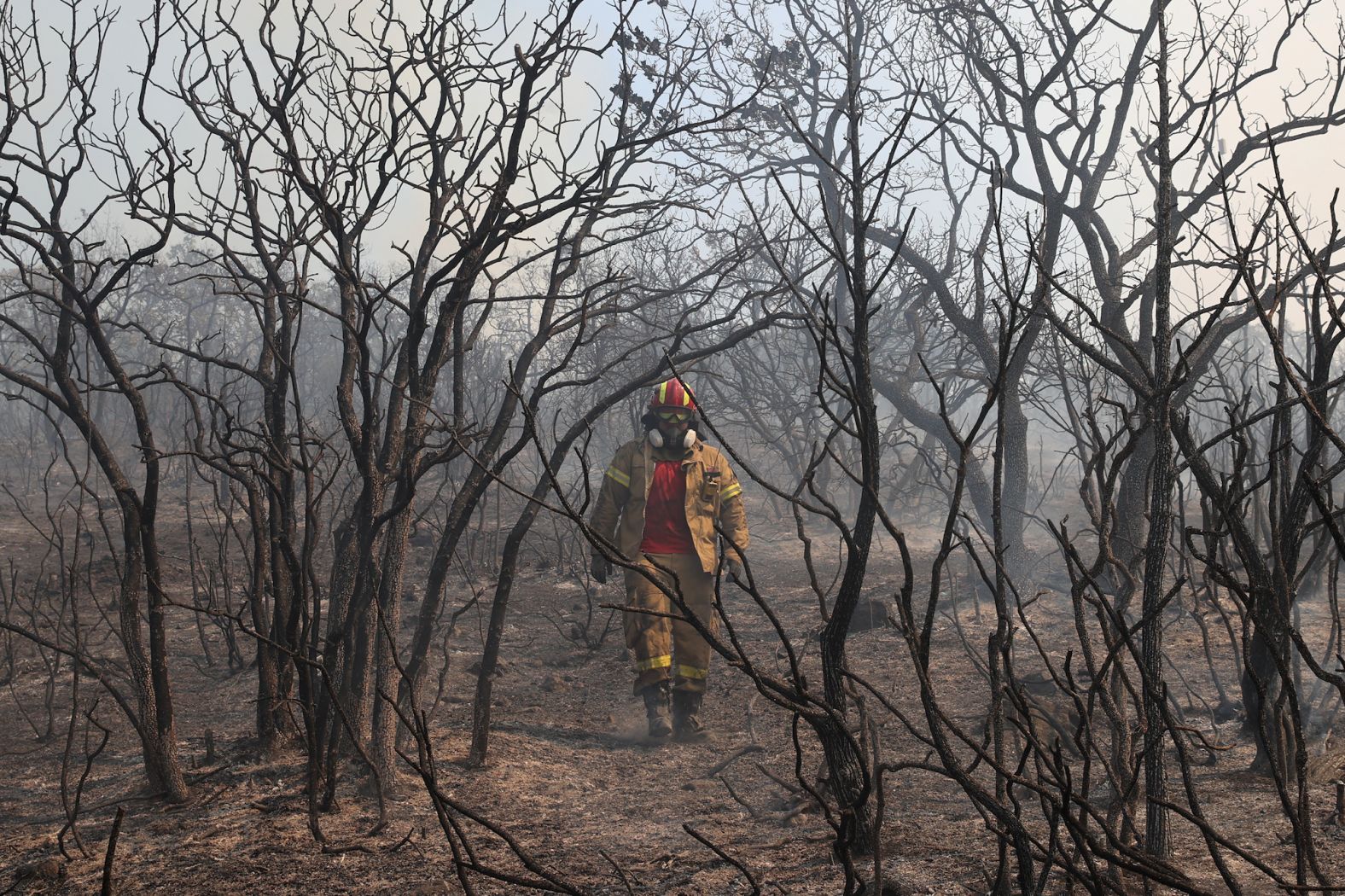 A firefighter works in the village of Kirki on August 23.