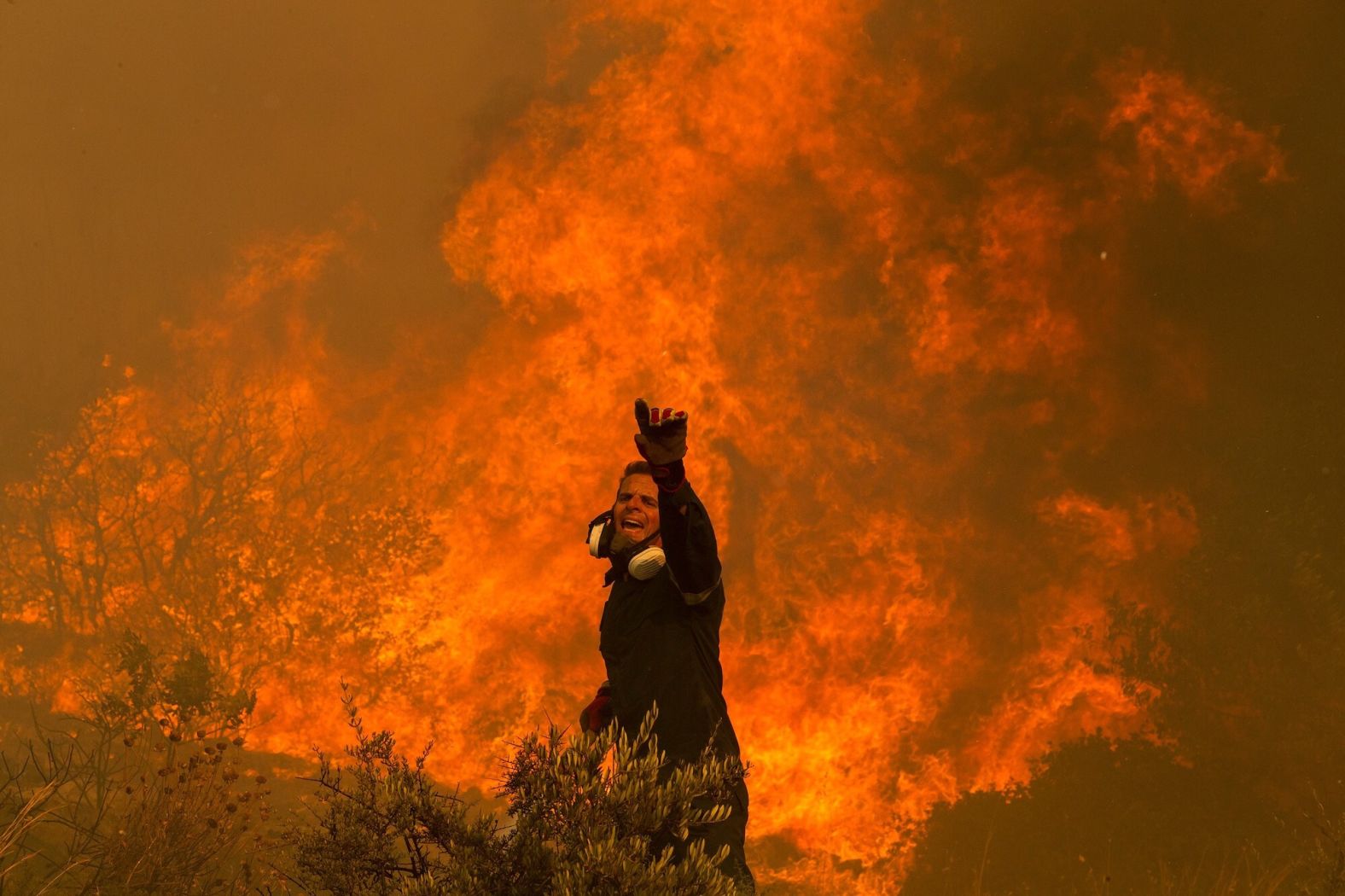 A firefighter battles a wildfire in the Hasia village on August 22.