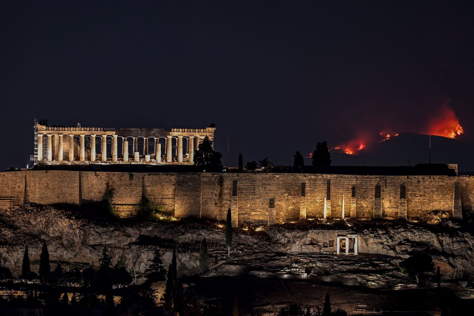 A forest burns behind the Parthenon in Athens on August 22.