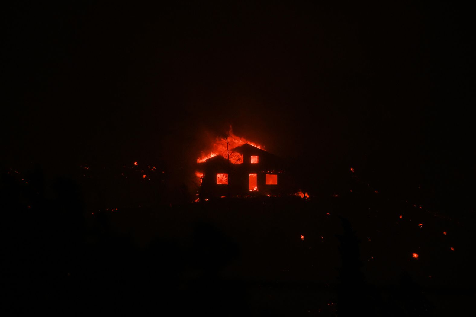 A house is consumed by a wildfire in Avantas on August 21.