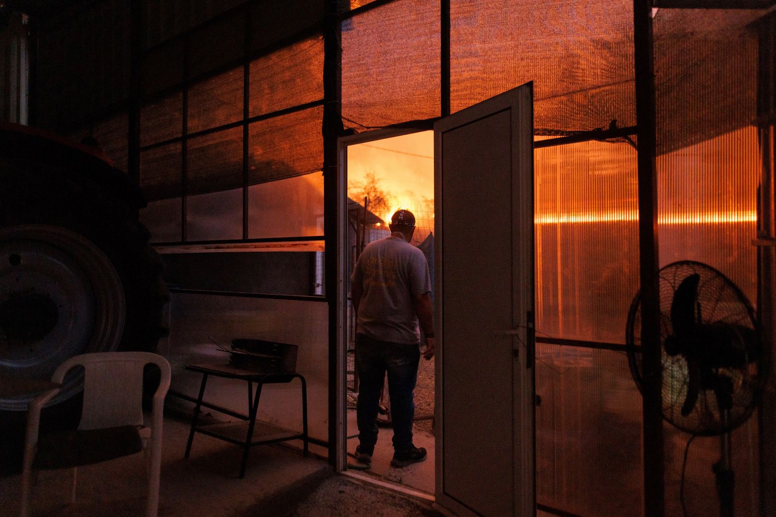 A local resident watches a wildfire in Avantas on August 21.