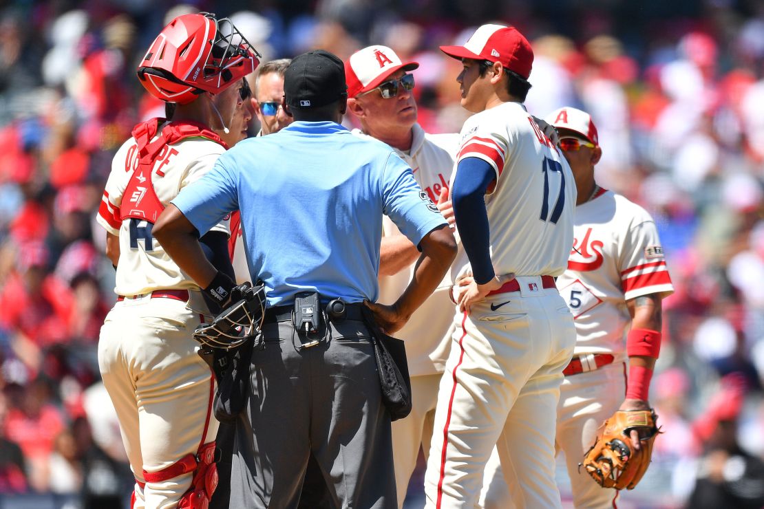 ANAHEIM, CA - AUGUST 23: Manager Phil Nevin checks on Los Angeles Angels pitcher Shohei Ohtani (17) during the MLB game 1 of a doubleheader between the Cincinnati Reds and the Los Angeles Angels of Anaheim on August 23, 2023 at Angel Stadium of Anaheim in Anaheim, CA. (Photo by Brian Rothmuller/Icon Sportswire via Getty Images)