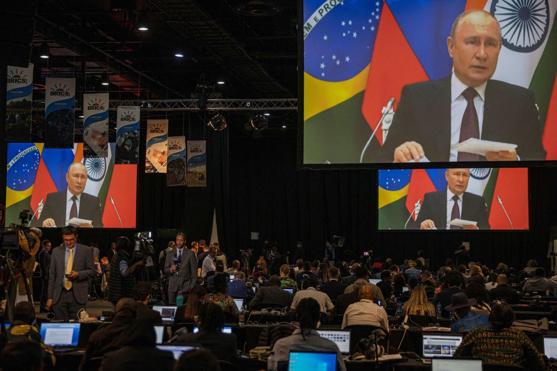 A screen in the media centre shows Russian President Vladimir Putin delivers his remarks via video-link during the 2023 BRICS Summit at the Sandton Convention Centre in Johannesburg on August 24, 2023. (Photo by Michele Spatari / AFP) (Photo by MICHELE SPATARI/AFP via Getty Images)
