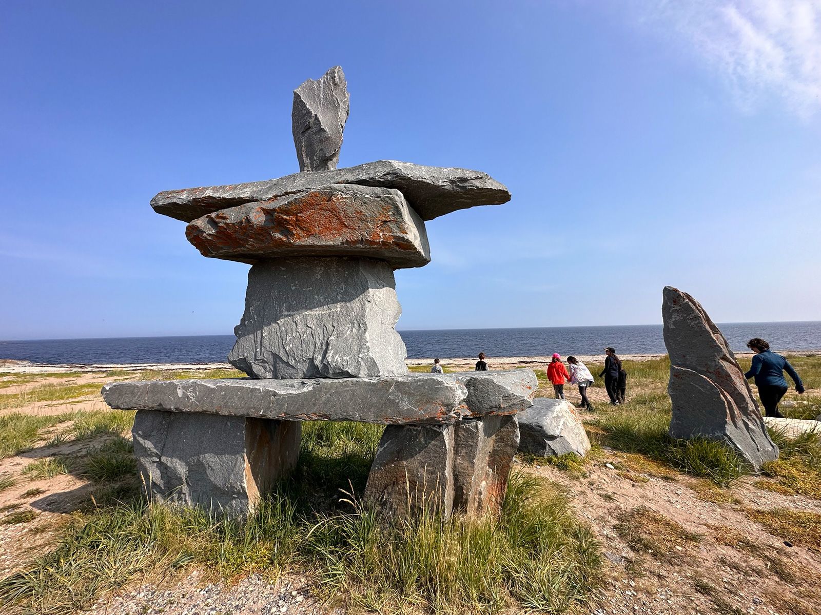 An Inukshuk, a structure of boulders piled to look like a person, fronts Churchill’s city beach.