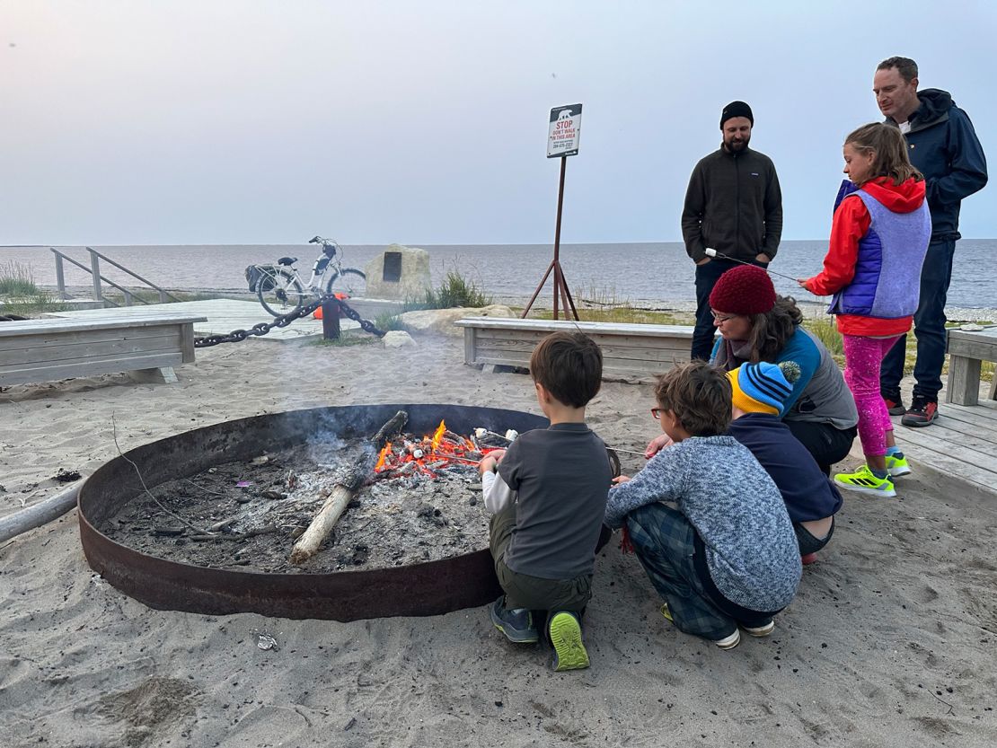 With a polar bear guard scouting the perimeter, Frontiers North Adventure guests roast s’mores at a bonfire on Churchill’s city beach.